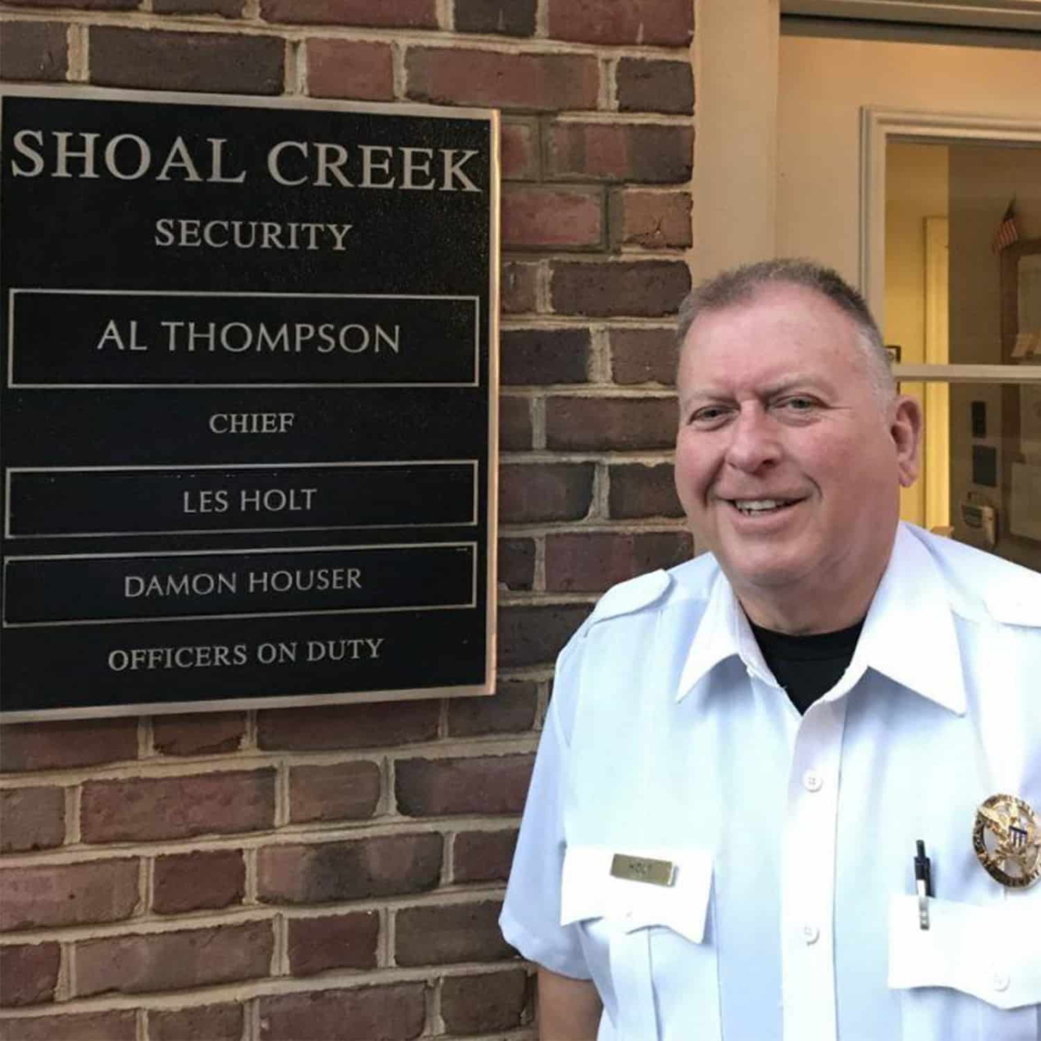 Shoal Creek Security Officer with on duty sign