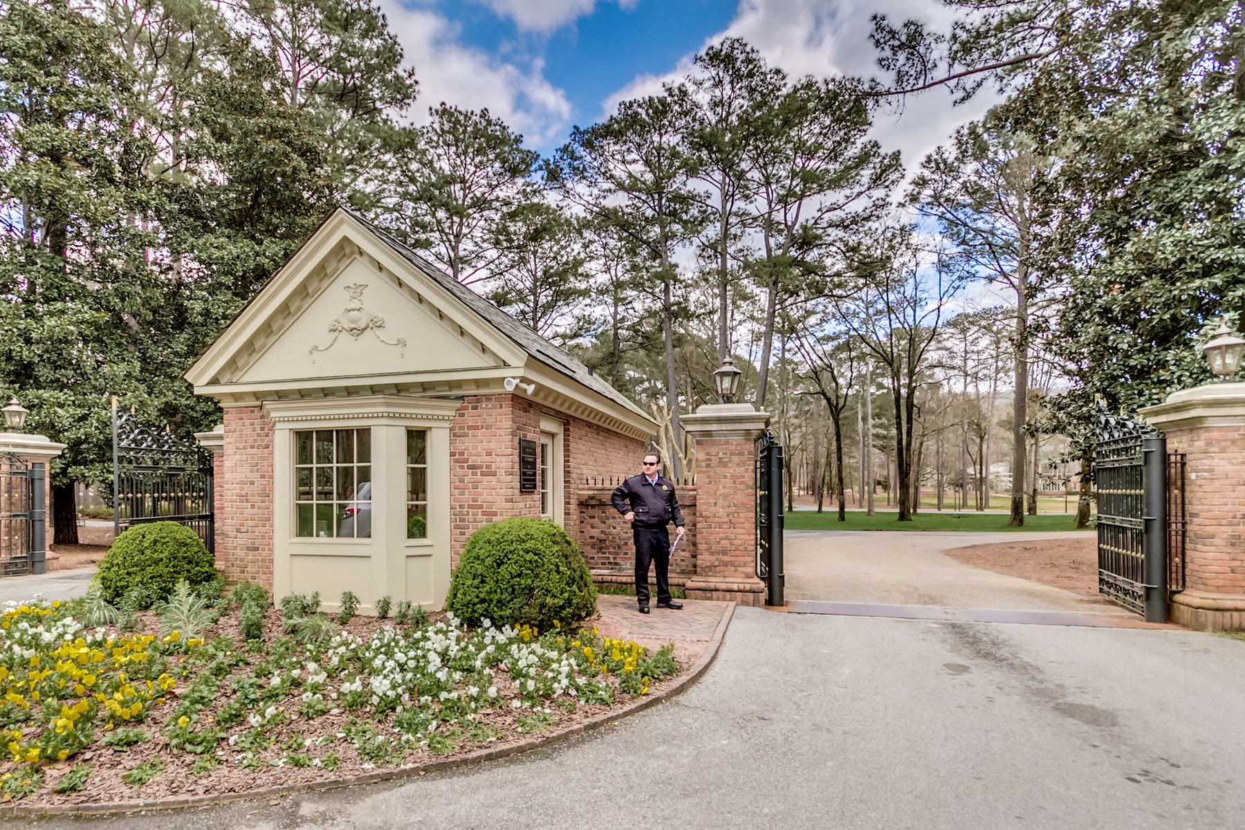 Shoal Creek front gate with security guard