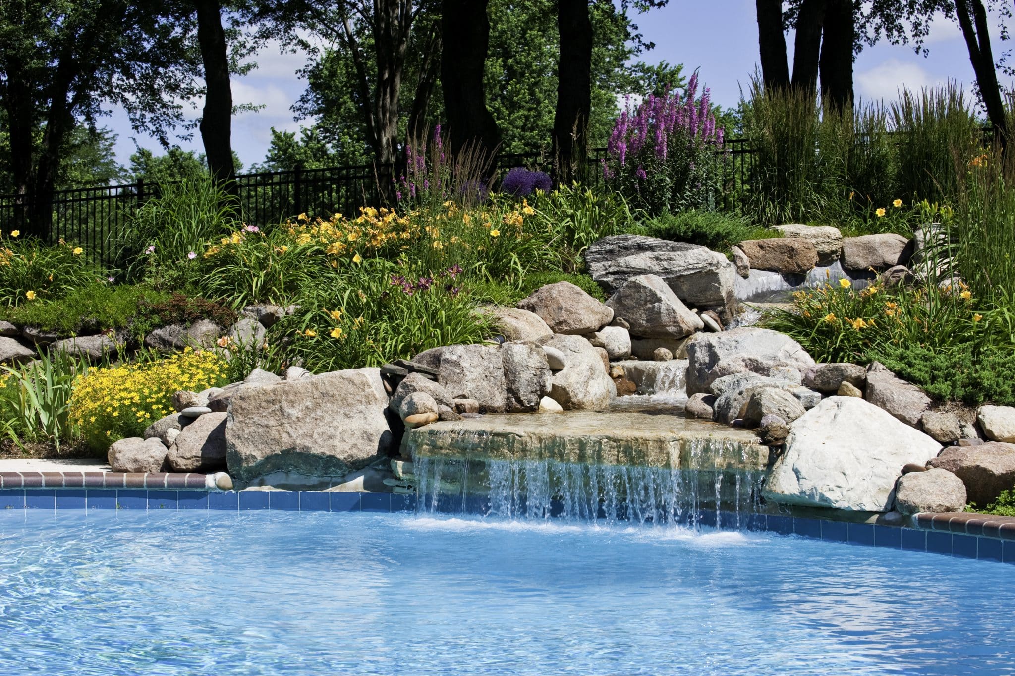A garden surrounding a luxury pool provides privacy