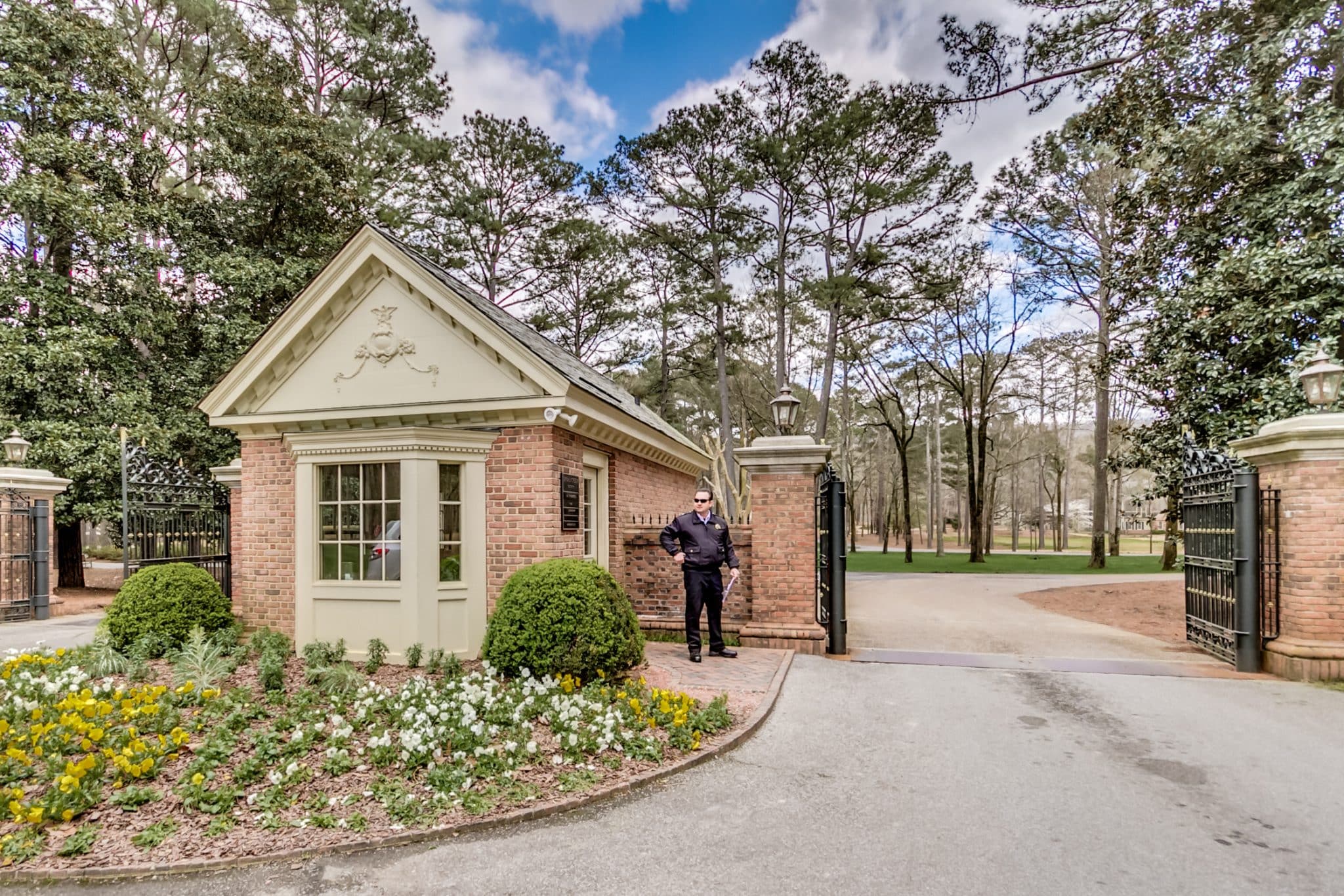 Shoal Creek’s gated entry, with security officer standing guard 24/7, 365. Gated communities offer peace of mind.