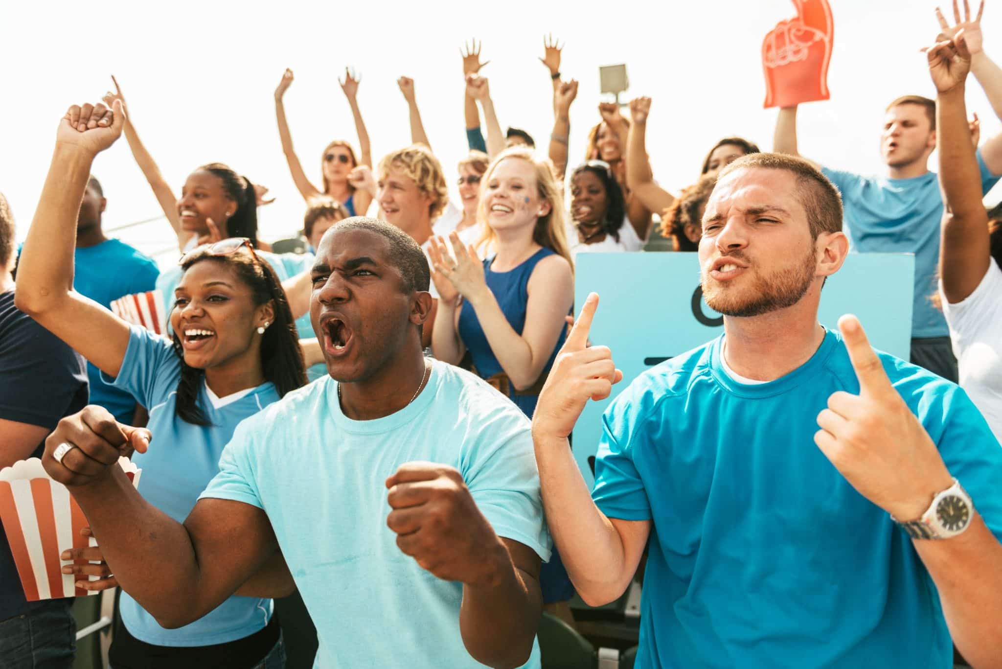 An energetic crowd cheering for their favorite competitor to encourage attendance at The World Games 2022