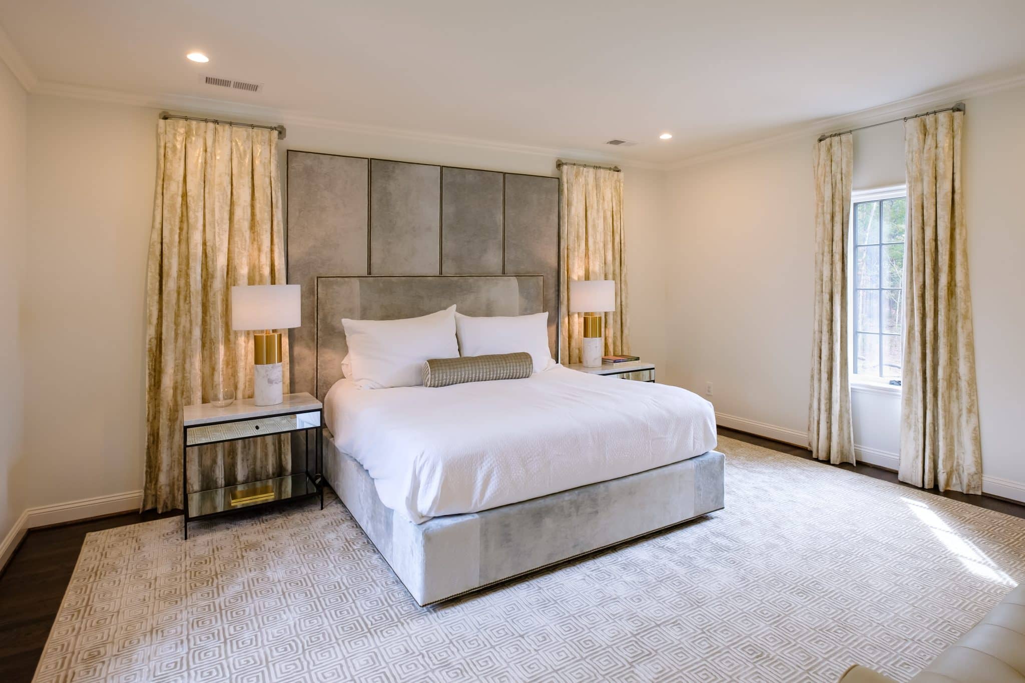 A luxury bedroom interior at Shoal Creek with a white, gold, and grey color scheme