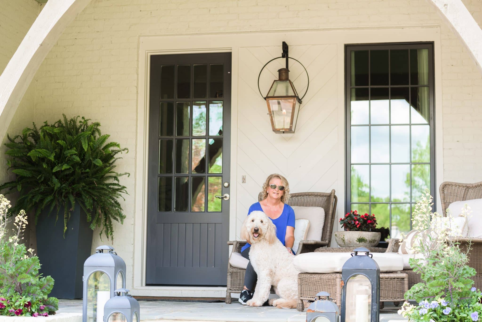 A Shoal Creek resident sits on the porch of her new construction home in Birmingham with her dog