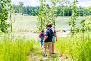 3 Shoal Creek children explore the land