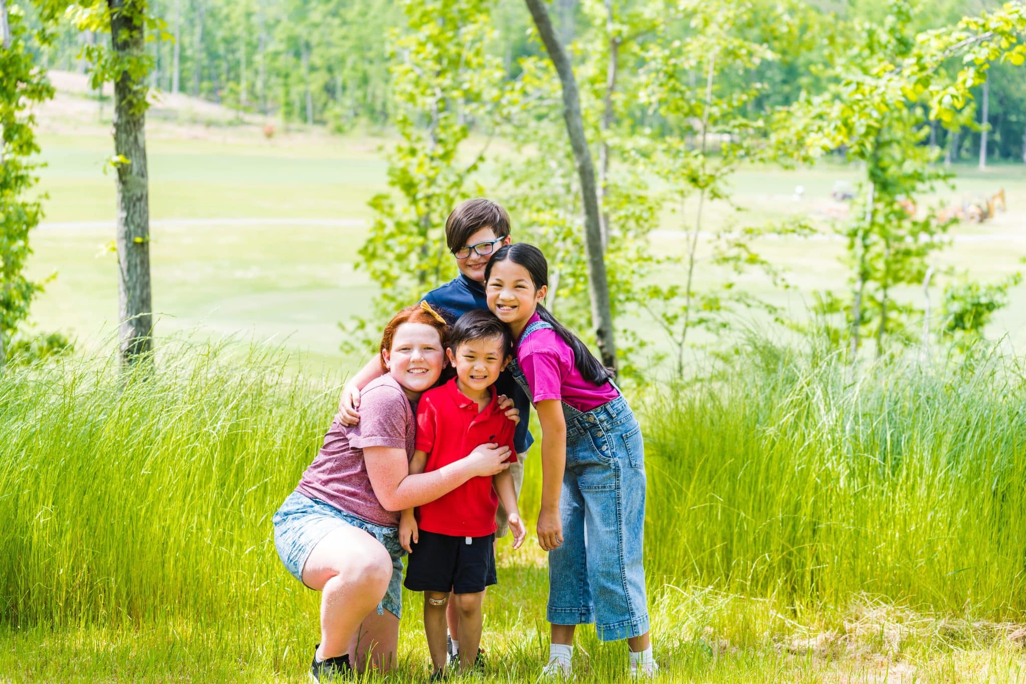 children smiling and posing for an outdoor image