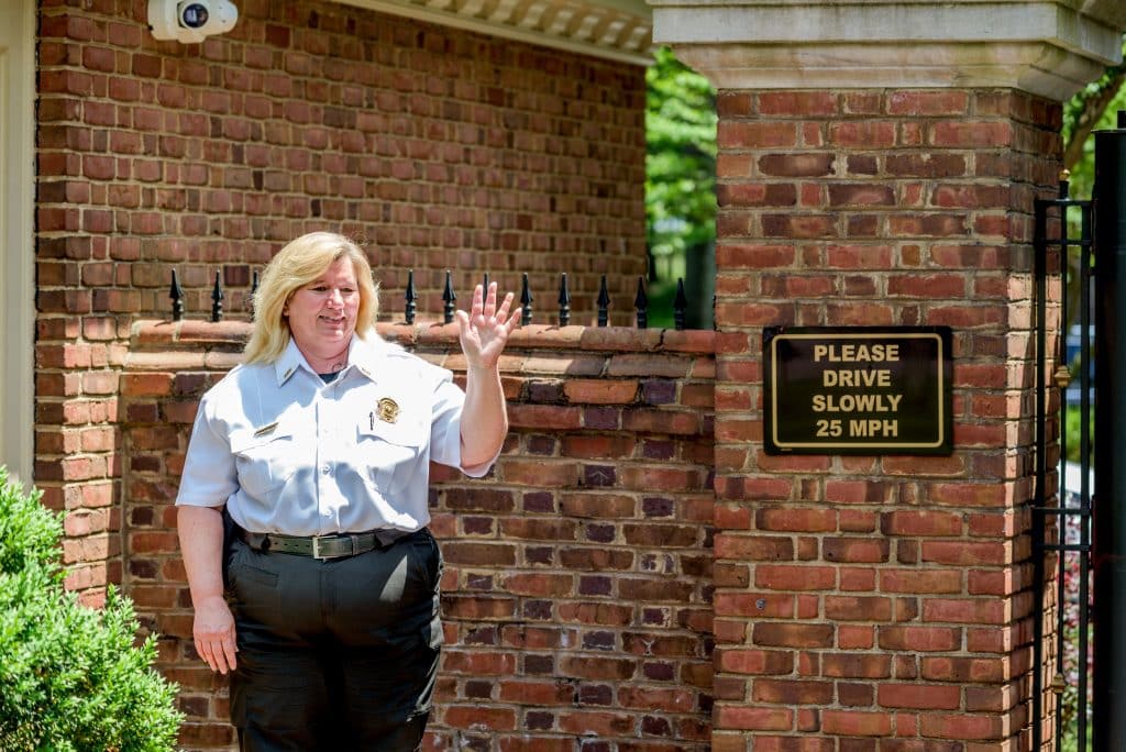 A Shoal Creek security guard waves at the camera