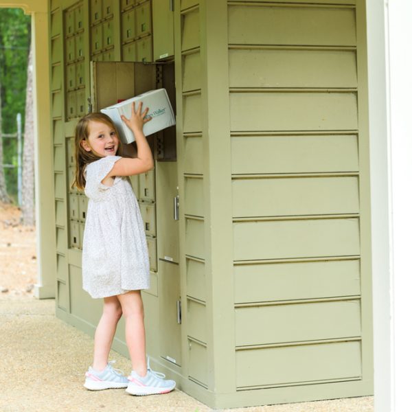Girl smiling picking up a package