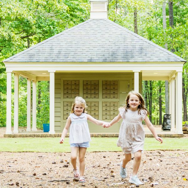Two girls smiling holding hands