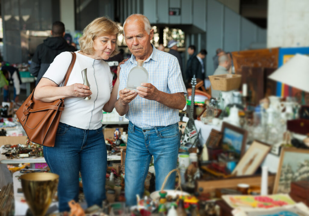 An older couple shopping for antique home decor for their custom home.