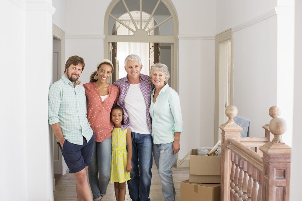 Family smiling together in a home inspired by classic architecture styles. 