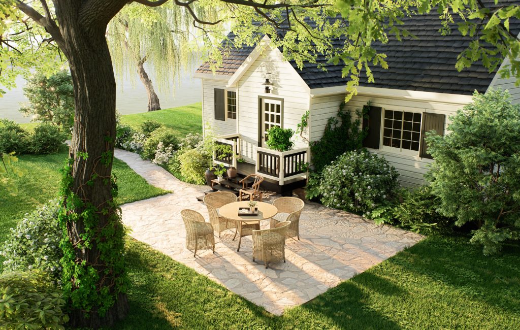 Cozy cottage patio with wicker furniture overlooking a peaceful lake, capturing quiet community living